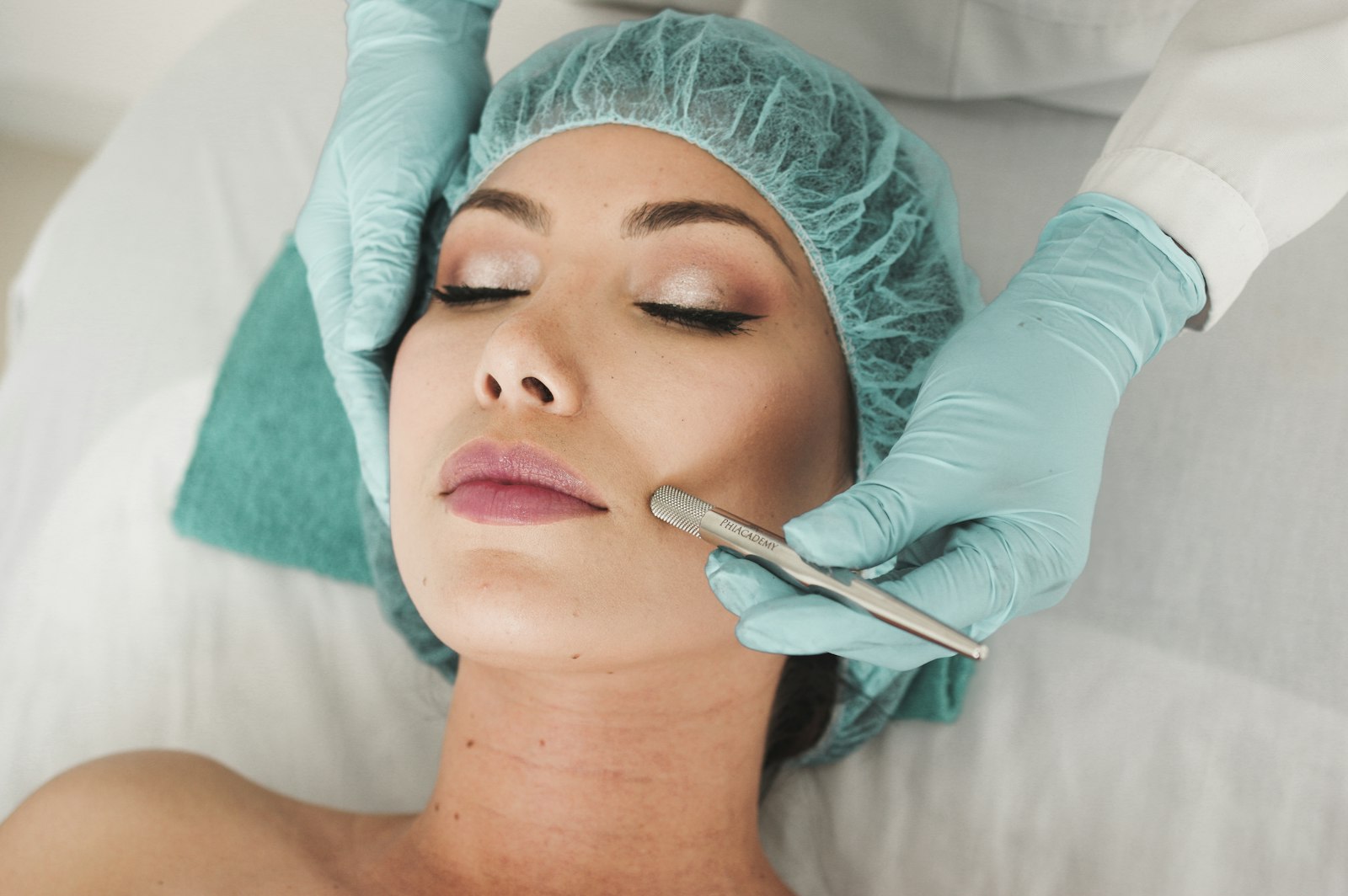 A client receiving a skin treatment from a gloved therapist