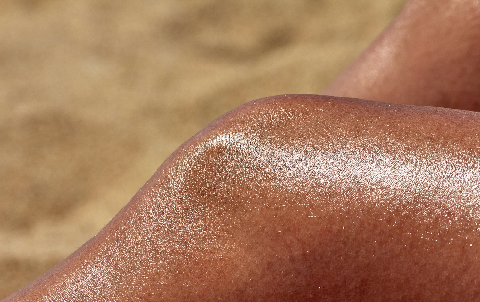 Close-up of a person's bronzed legs